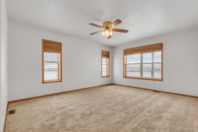 unfurnished room featuring carpet and ceiling fan