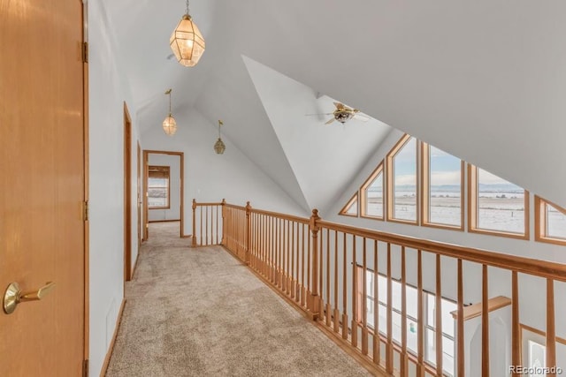 corridor featuring light carpet and lofted ceiling