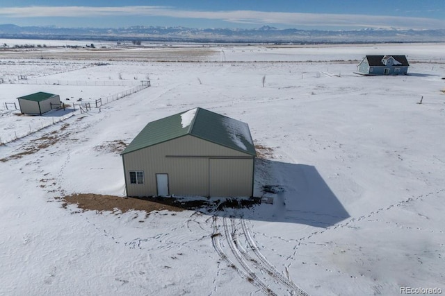 snowy aerial view featuring a mountain view