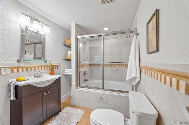 3002 Quitman St, Denver, CO 80212 - bathroom with tiled shower / bath combo, a textured ceiling, vanity, tile patterned flooring, and a textured wall