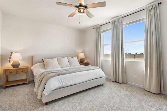 carpeted bedroom with baseboards and ceiling fan