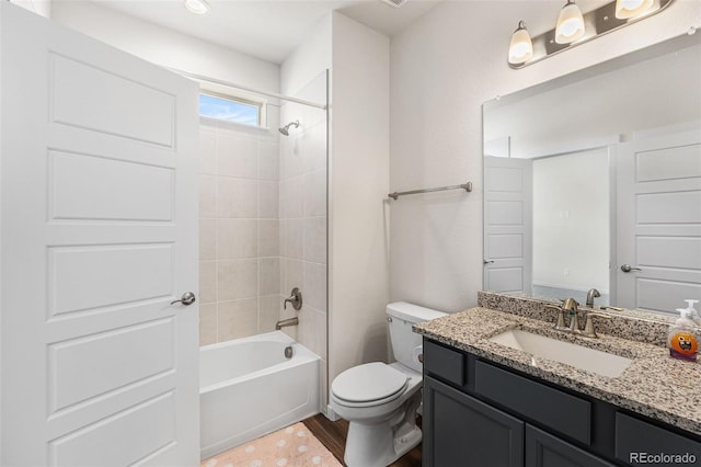 bathroom featuring toilet, wood finished floors, vanity, and shower / bath combination