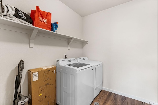 washroom featuring baseboards, dark wood-style floors, laundry area, and washer and dryer