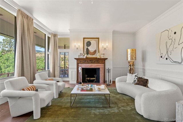 sitting room with dark hardwood / wood-style flooring, a high end fireplace, and ornamental molding