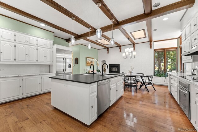 kitchen with white cabinetry, light hardwood / wood-style flooring, sink, and appliances with stainless steel finishes