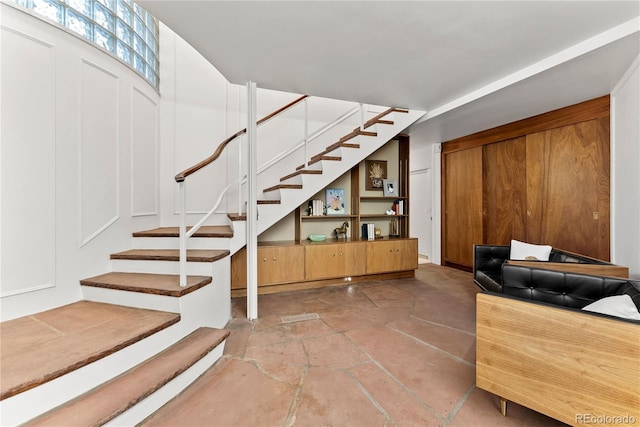 stairway with stone tile floors