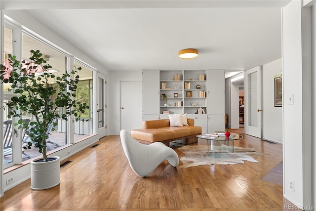 living area featuring light hardwood / wood-style floors and french doors