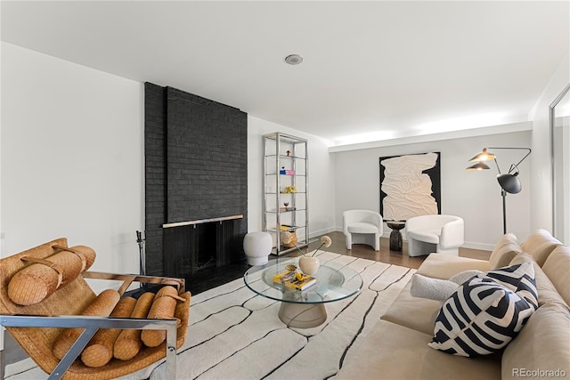 living room with a fireplace and wood-type flooring