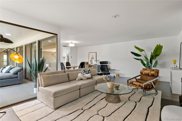 living room with baseboards and wood finished floors