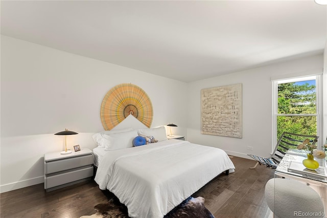 bedroom with baseboards and wood finished floors