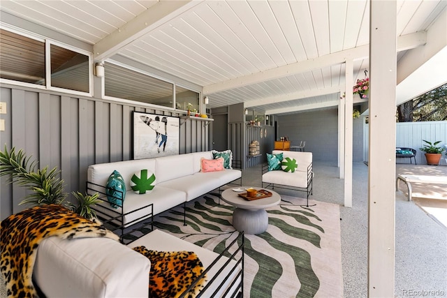 view of patio with an outdoor living space and fence