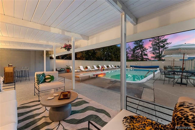 view of pool with a fenced backyard, a fenced in pool, outdoor dining space, and a patio area