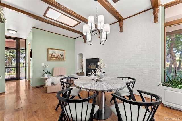 dining area with light wood finished floors, brick wall, and ornamental molding