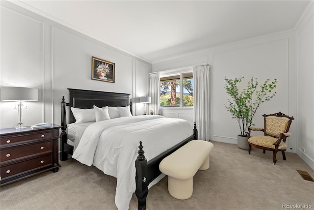 bedroom with light carpet, visible vents, crown molding, and a decorative wall