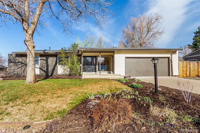 6052 Taft St, Arvada, CO 80004 - ranch-style home with a garage, a front lawn, fence, and driveway