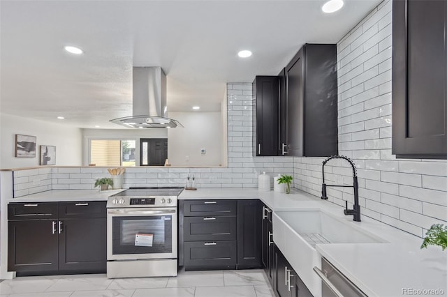6052 Taft St, Arvada, CO 80004 - kitchen featuring marble finish floor, recessed lighting, light countertops, island exhaust hood, and stainless steel range with electric cooktop