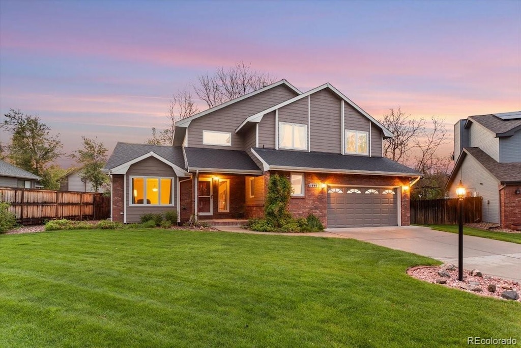 1444 Wakerobin Ct, Fort Collins, CO 80526 - view of front facade featuring brick siding, concrete driveway, and an attached garage