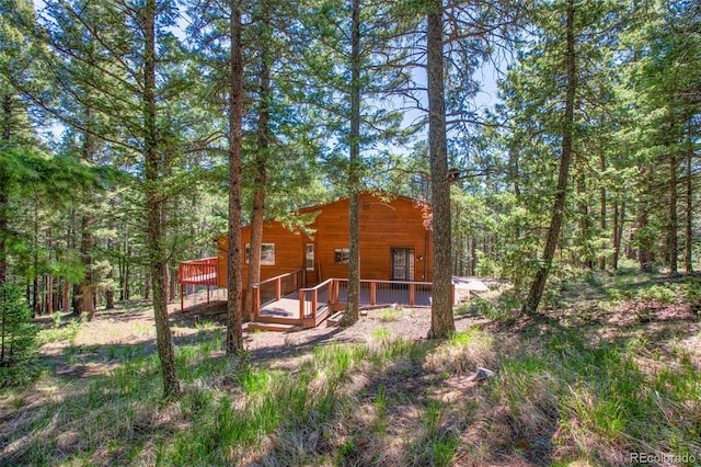 back of house featuring a wooden deck
