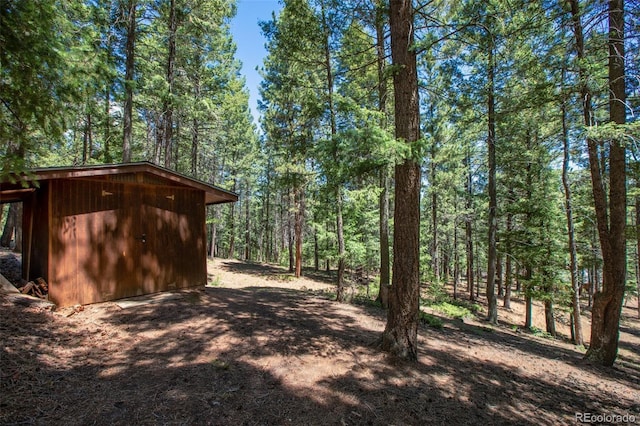 view of outdoor structure with an outdoor structure and a wooded view