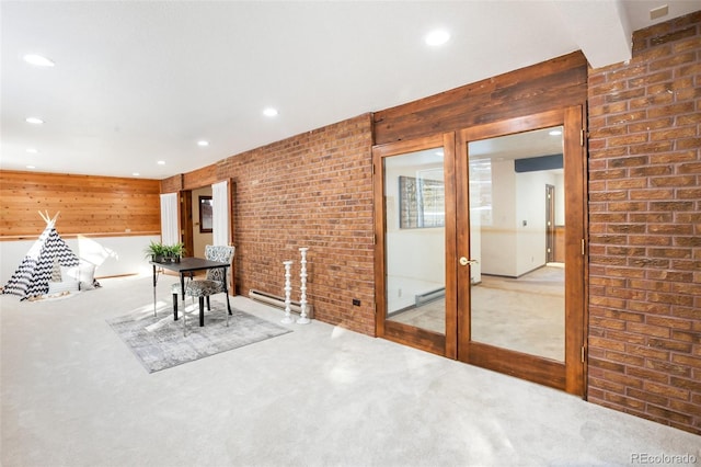 unfurnished dining area with recessed lighting, brick wall, and carpet