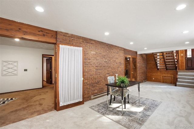 interior space featuring light carpet, stairway, recessed lighting, and brick wall