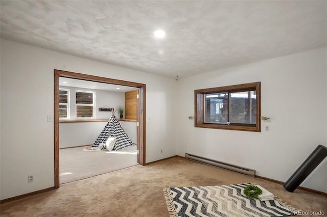 interior space featuring recessed lighting, a baseboard heating unit, baseboards, and carpet