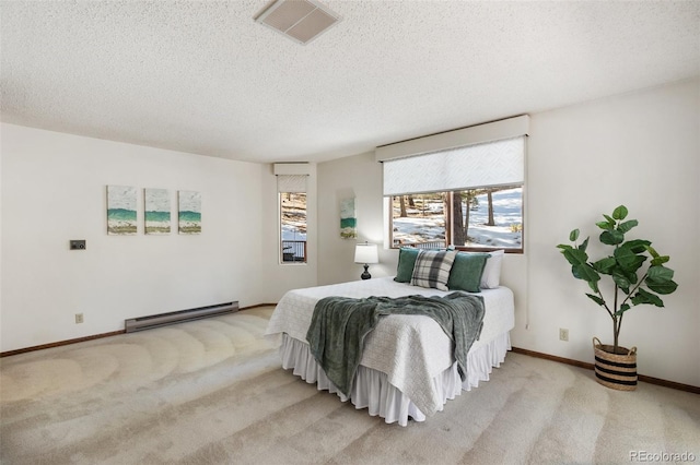 carpeted bedroom with visible vents, a baseboard heating unit, baseboards, a textured ceiling, and a wall mounted AC