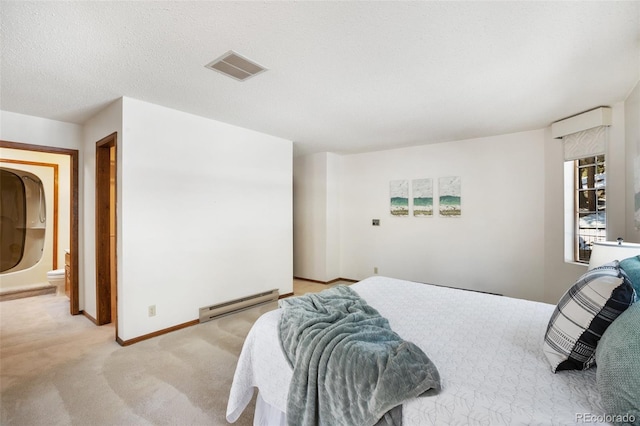 bedroom featuring visible vents, light carpet, a baseboard heating unit, a textured ceiling, and baseboards