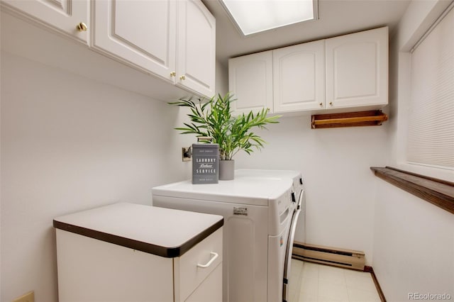 clothes washing area with washer and clothes dryer, baseboard heating, cabinet space, and baseboards