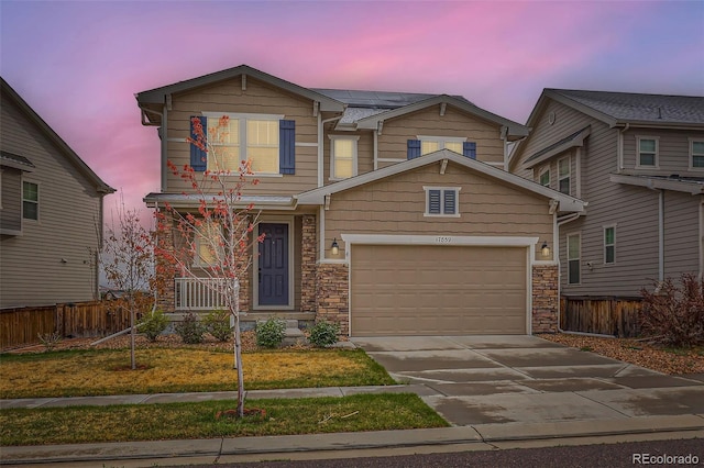 17859 E 108th Pl, Commerce City, CO 80022 - view of front of property featuring driveway, covered porch, roof mounted solar panels, fence, and a garage