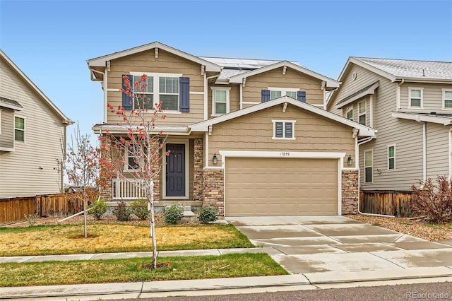 17859 E 108th Pl, Commerce City, CO 80022 - craftsman house with driveway, covered porch, fence, a garage, and roof mounted solar panels