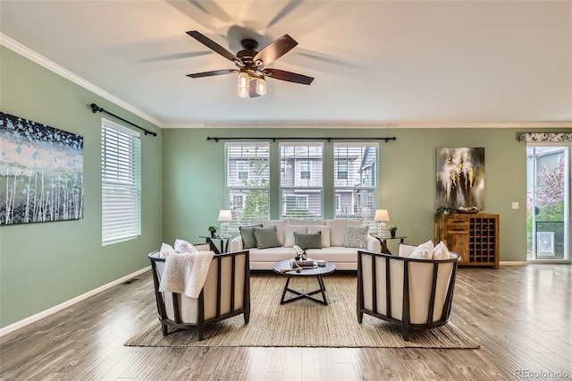 17859 E 108th Pl, Commerce City, CO 80022 - living area featuring a ceiling fan, baseboards, ornamental molding, and wood finished floors