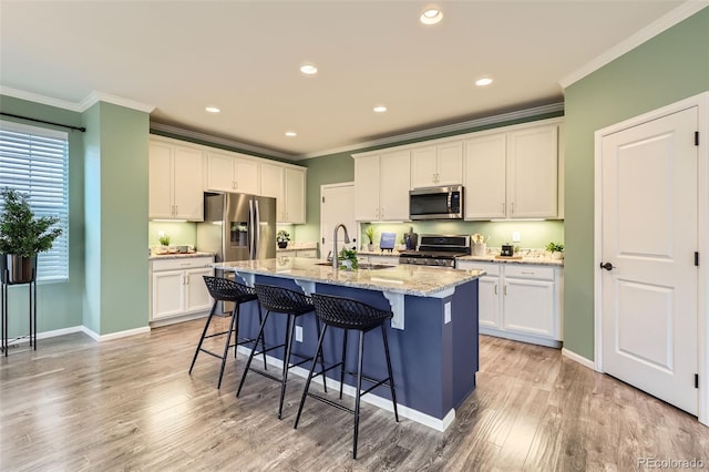 17859 E 108th Pl, Commerce City, CO 80022 - kitchen with a breakfast bar area, ornamental molding, stainless steel appliances, and a sink