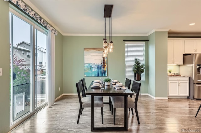 17859 E 108th Pl, Commerce City, CO 80022 - dining room featuring plenty of natural light, light wood-style flooring, baseboards, and ornamental molding