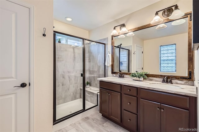 17859 E 108th Pl, Commerce City, CO 80022 - bathroom featuring a shower stall, a sink, and double vanity