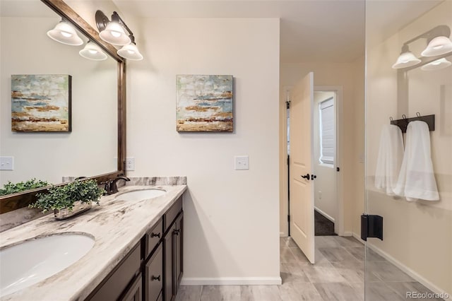 17859 E 108th Pl, Commerce City, CO 80022 - bathroom with double vanity, baseboards, and a sink