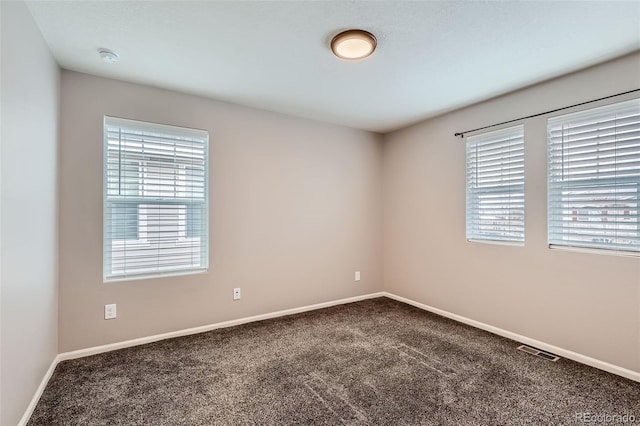 17859 E 108th Pl, Commerce City, CO 80022 - carpeted spare room featuring baseboards and a healthy amount of sunlight