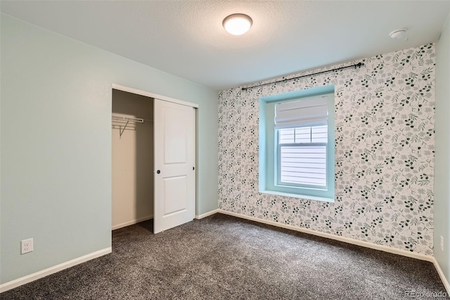 17859 E 108th Pl, Commerce City, CO 80022 - unfurnished bedroom featuring dark carpet, a closet, and baseboards