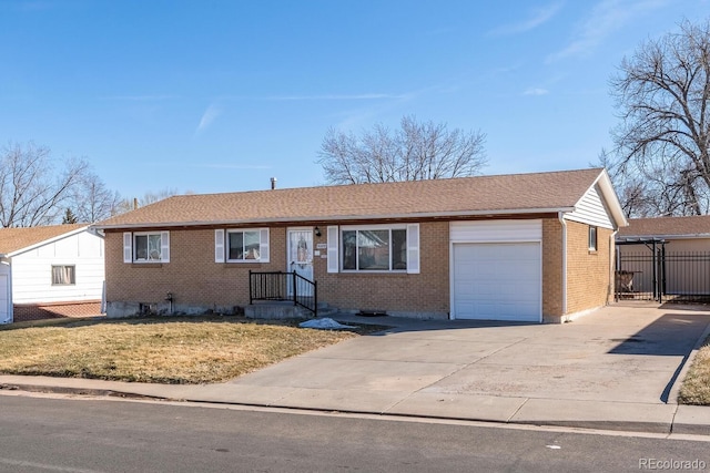 ranch-style house with brick siding, concrete driveway, fence, a garage, and a front lawn