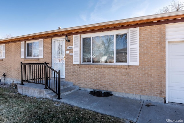 view of front facade featuring a garage and brick siding