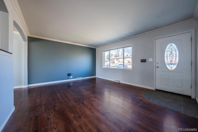 entrance foyer featuring baseboards, visible vents, ornamental molding, and wood finished floors