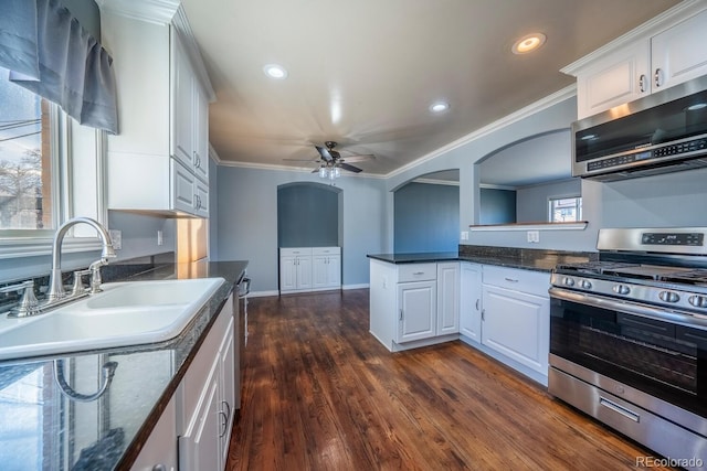 kitchen featuring ornamental molding, appliances with stainless steel finishes, a sink, and white cabinetry