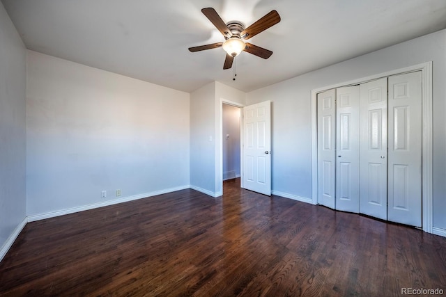 unfurnished bedroom with a ceiling fan, a closet, baseboards, and dark wood-style flooring