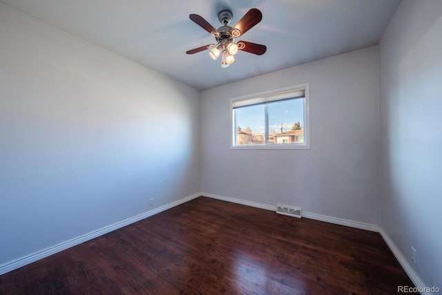 spare room with a ceiling fan, baseboards, visible vents, and wood finished floors