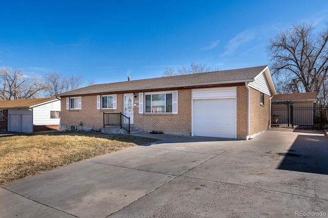 ranch-style home featuring a garage, concrete driveway, and brick siding