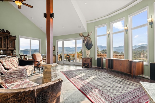 sunroom with a mountain view, lofted ceiling, and ceiling fan