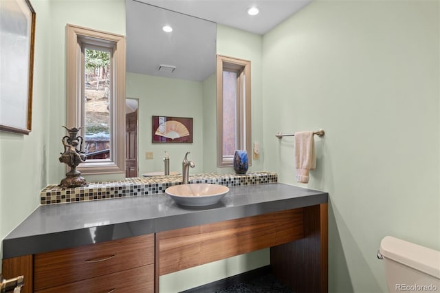 bathroom featuring vanity and toilet