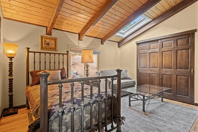 bedroom with wooden ceiling, vaulted ceiling with skylight, and light wood-type flooring