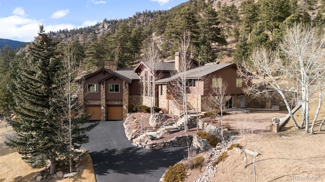 view of front of property with a garage and a mountain view