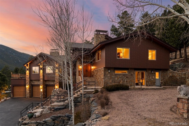view of front of house featuring a garage and a mountain view